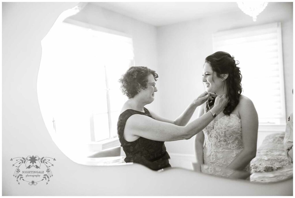 bride's mother helps her get ready for her napa wedding