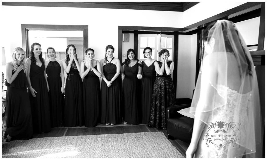 Bridesmaids see the bride in her gown for the first time at charles krug winery in napa