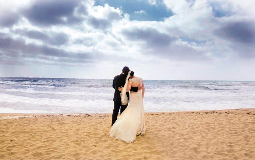 Bride and groom on beach at their Ritz-Carlton Half Moon Bay wedding 