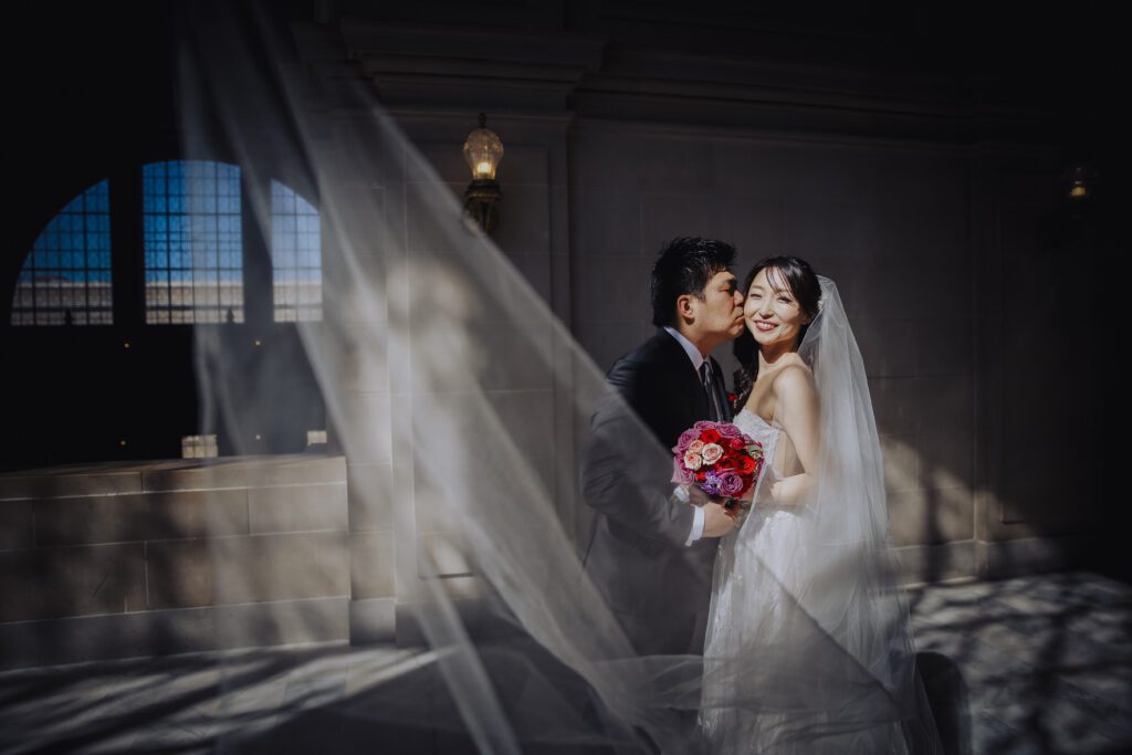 Wedding couple in dramatic light at City Hall in San Francisco