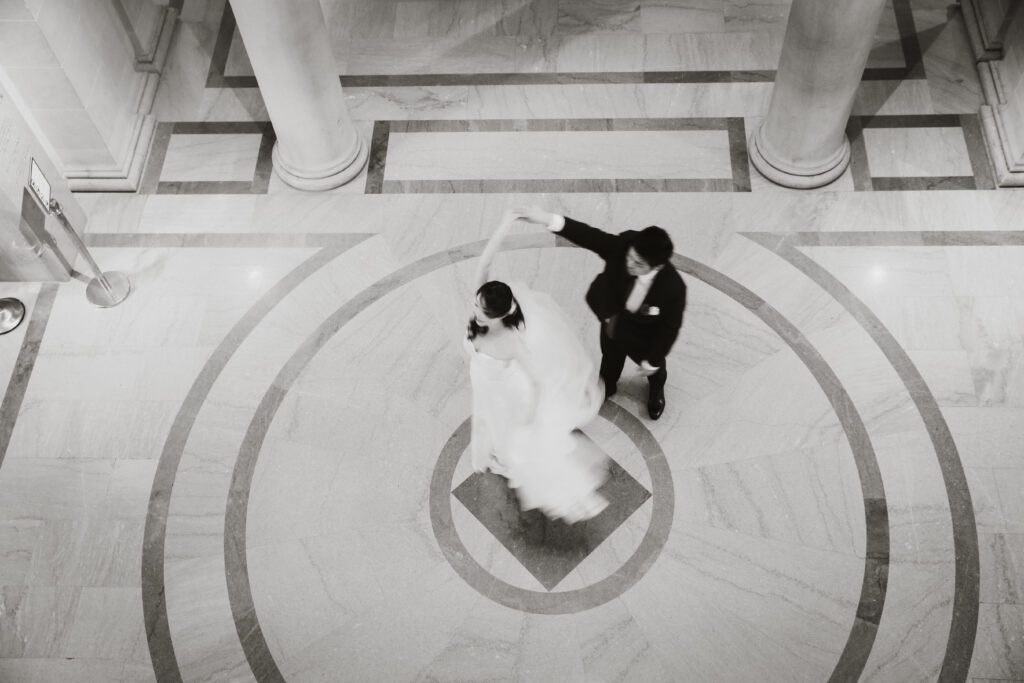 Groom spins bride during dance in San Francisci