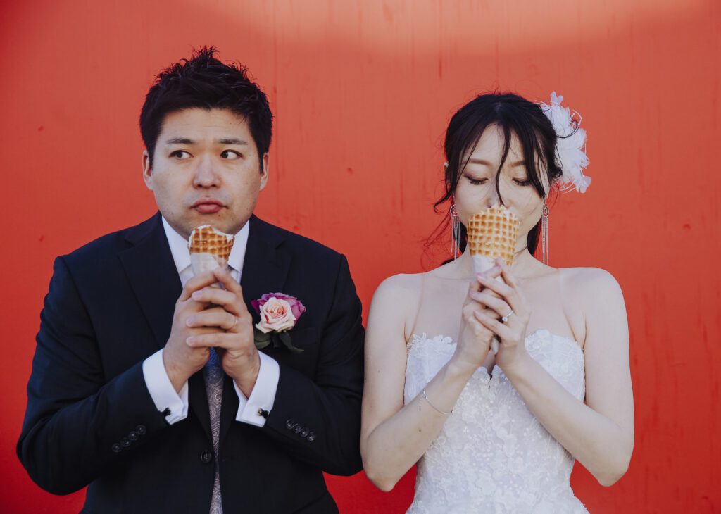 Modern wedding couple eat ice cream in San Francisco