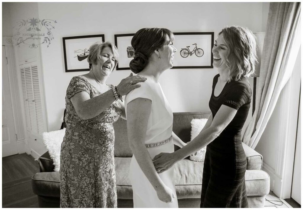Mother of bride and her sister help her getting ready