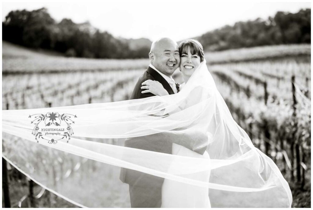 Wedding photo of couple in sonoma winery with grapevines