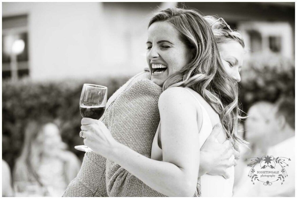 Bride hugs guests at the outdoor wedding reception in Piedmont, Ca