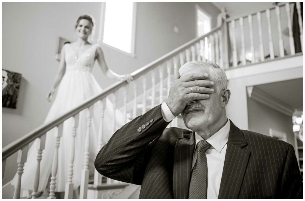 father gets ready to see his daughter in her wedding gown
