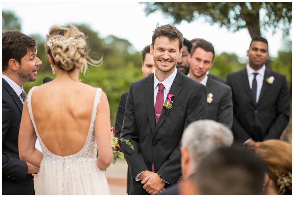 groom laughs during the ceremony at concannon vineyards