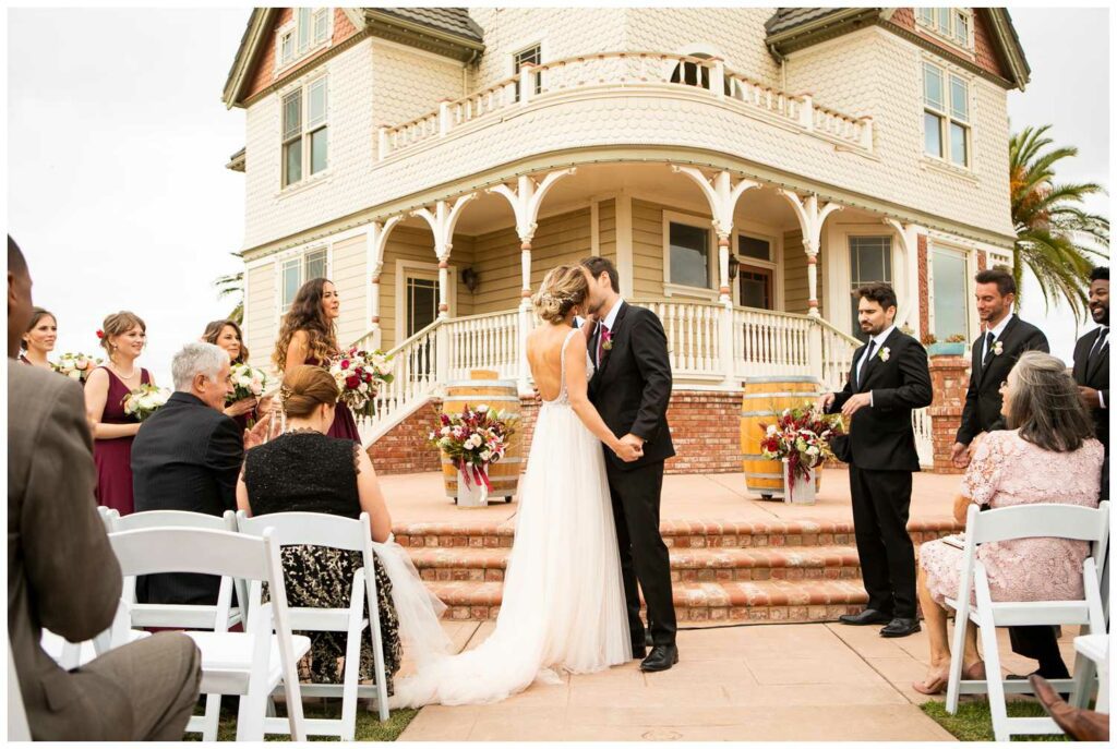 first kiss for bride and groom at california vineyard wedding