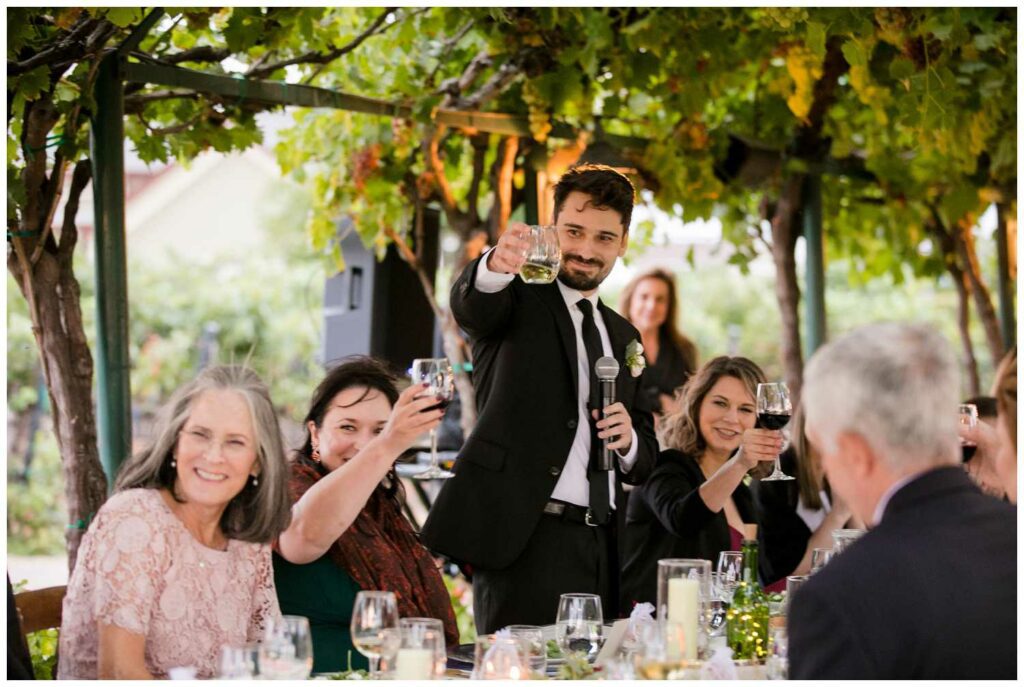 wedding guest gives toast at winery in napa valley