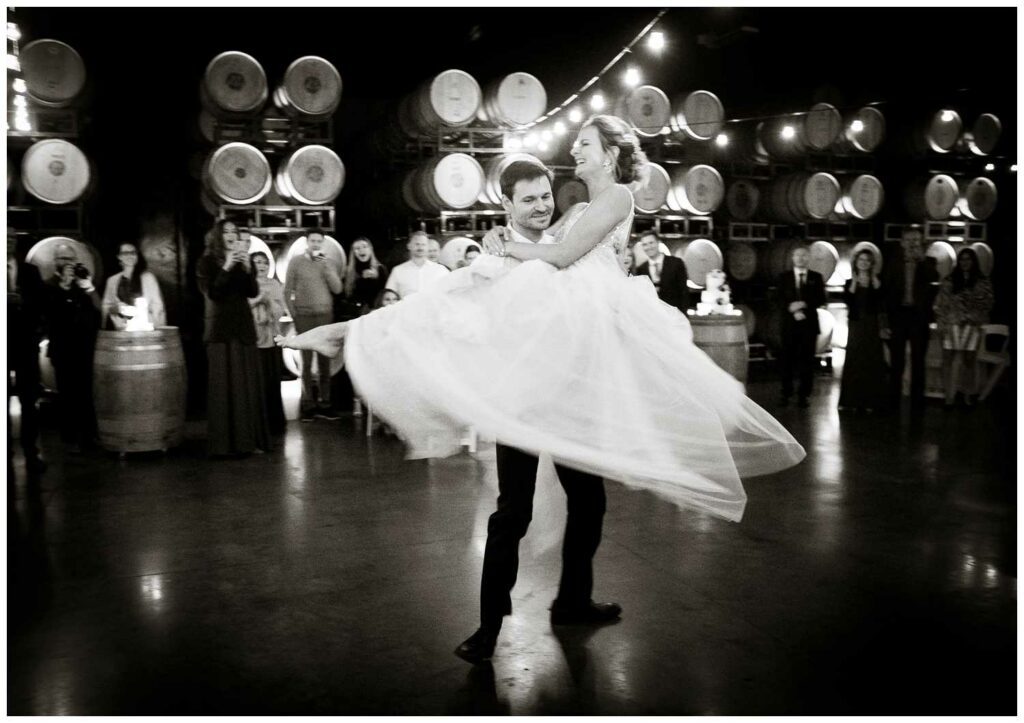 couple dances at their wedding reception in barrel room