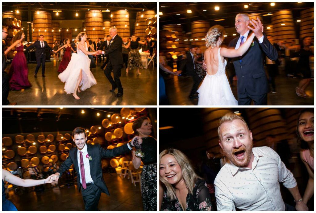 Guests dance at their winery wedding reception in a barrel room