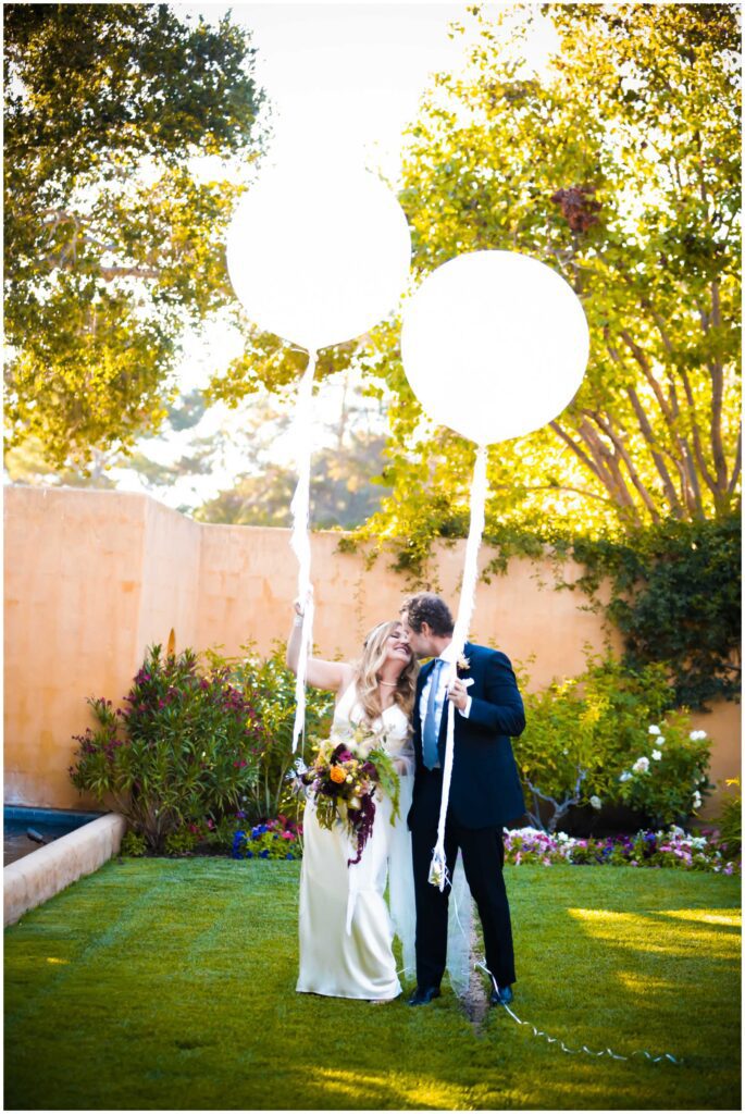micro wedding photos from carmel valley. The couple holding large balloons at carmel valley wedding venue, bernardus lodge