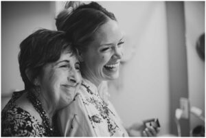 a bride gets a kiss from her mother before her wedding