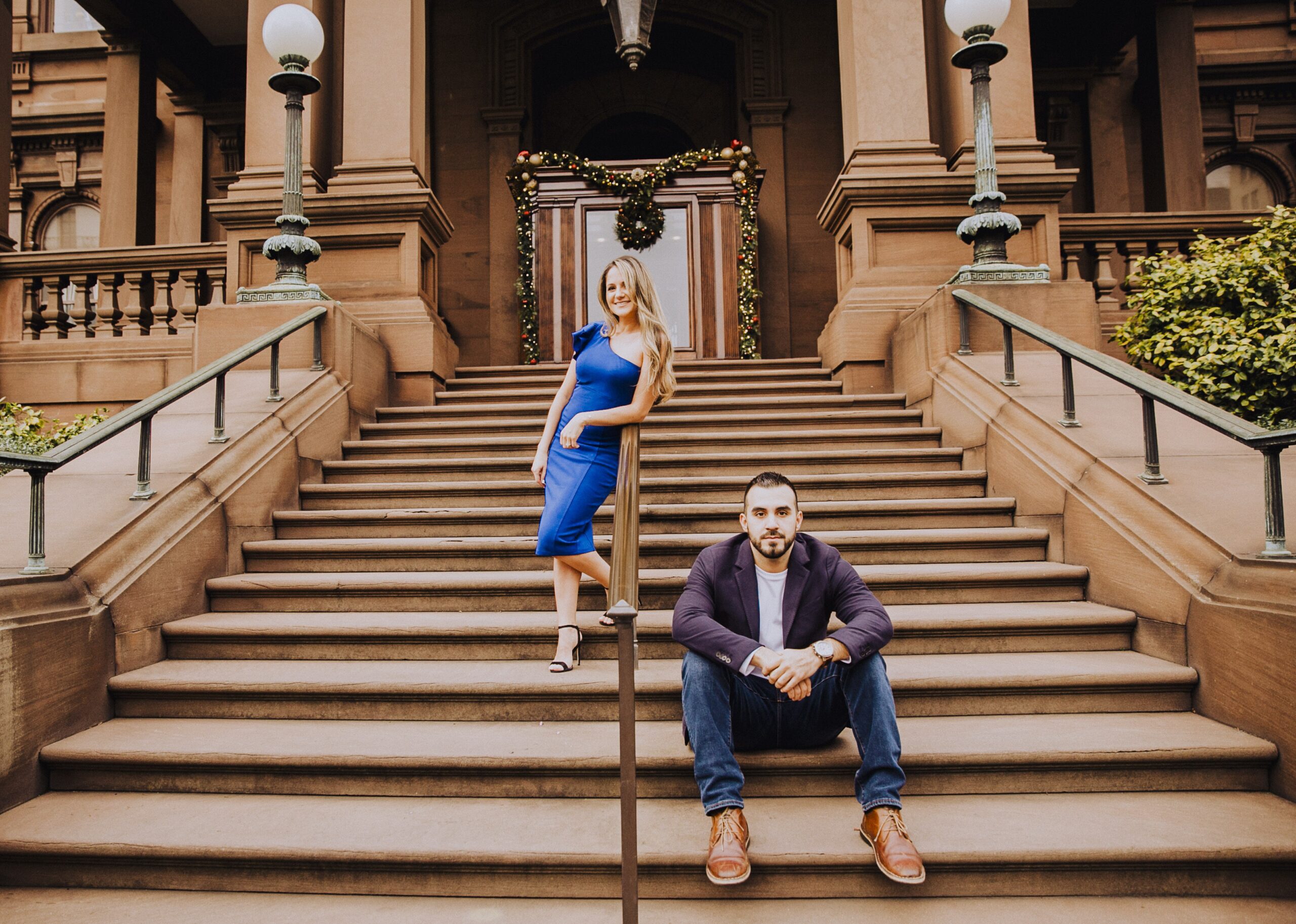 stylish couple on steps of building on nob hill in san francisco by Nightingale Photography