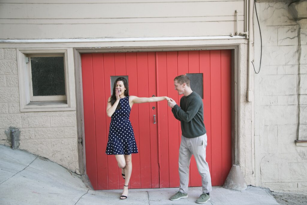 couple during photo session in san francisco with red door by Nightingale Photography