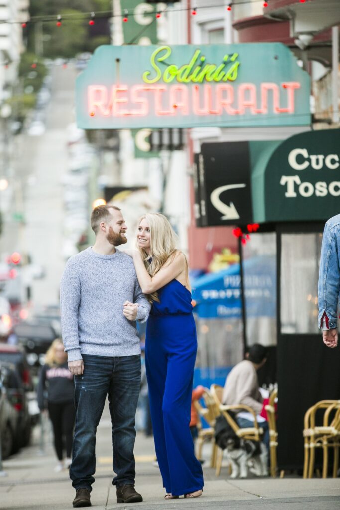 couple walks the streets of north beach in san francisco by Nightingale Photography