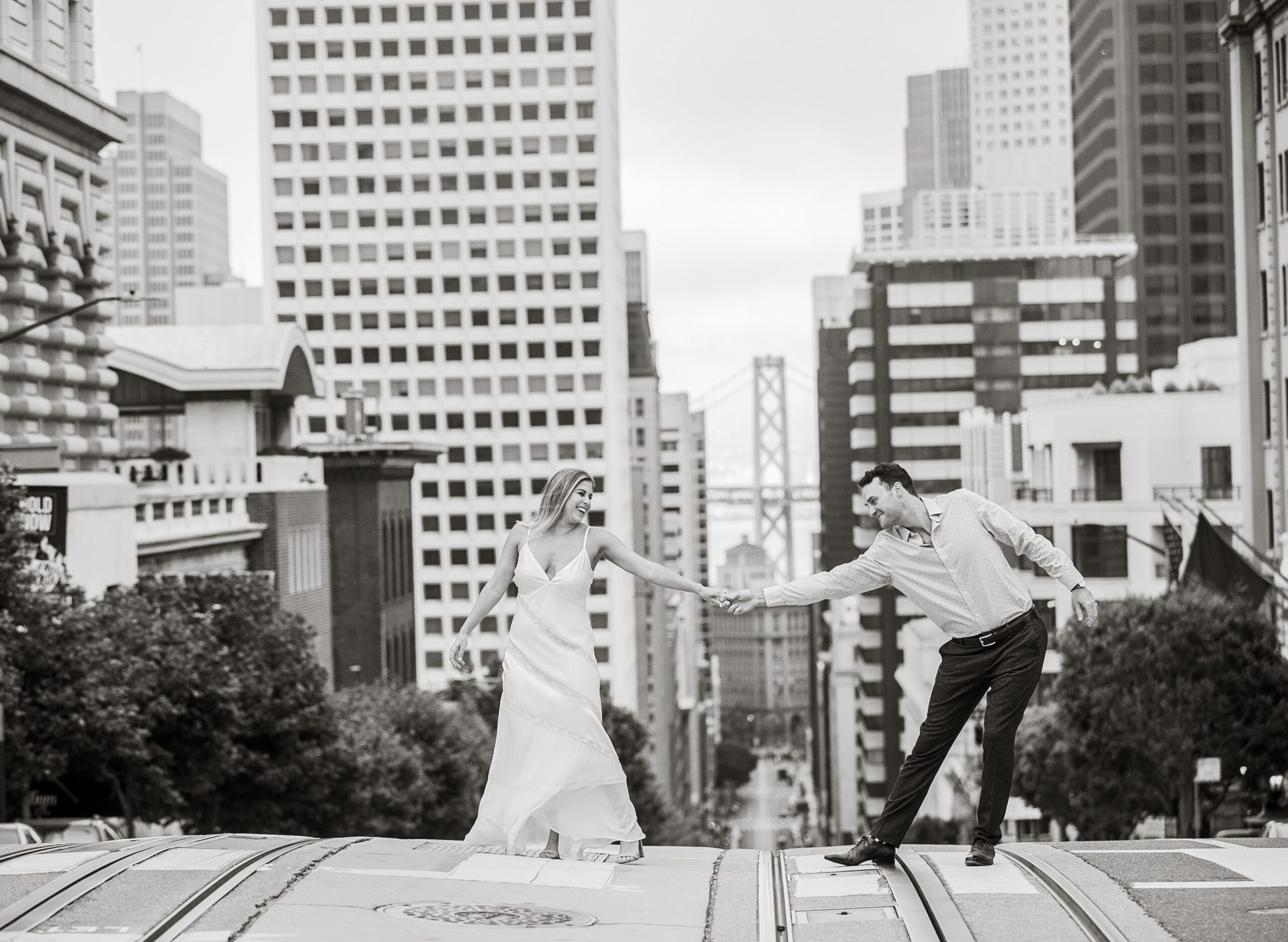 couple crosses street with views in san francisco by Nightingale Photography